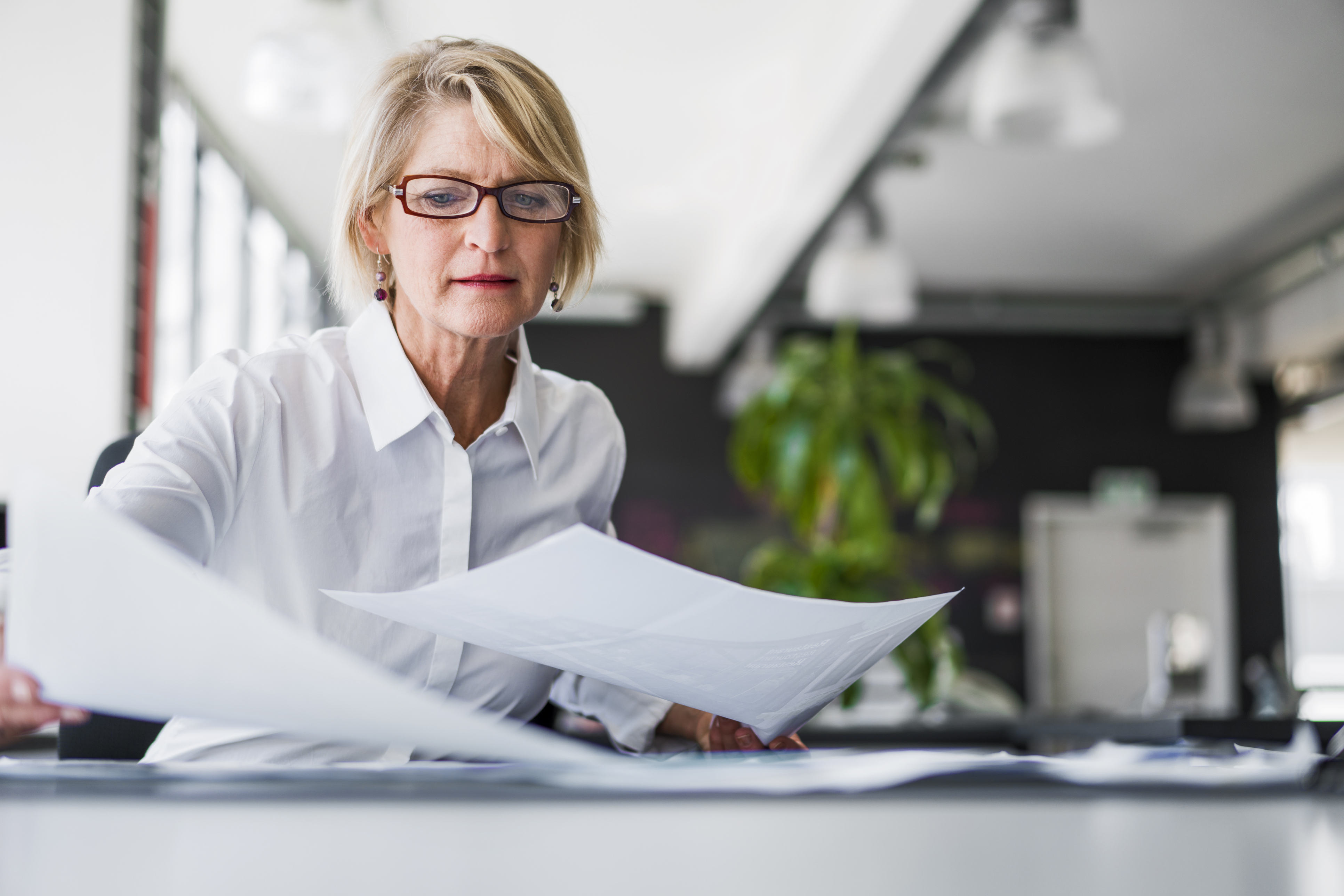 Woman reading documents on can an irrevocable trust be changed