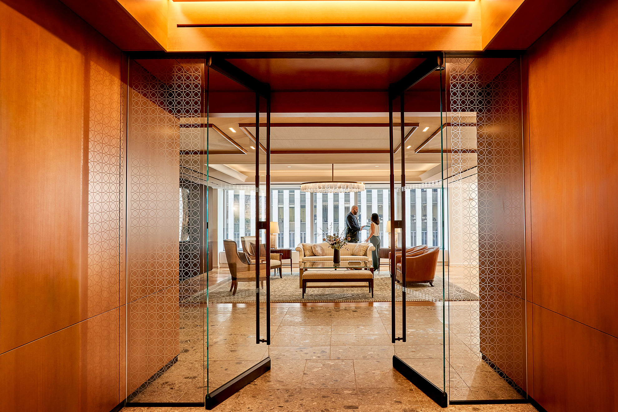 People greet each other in office welcome area.