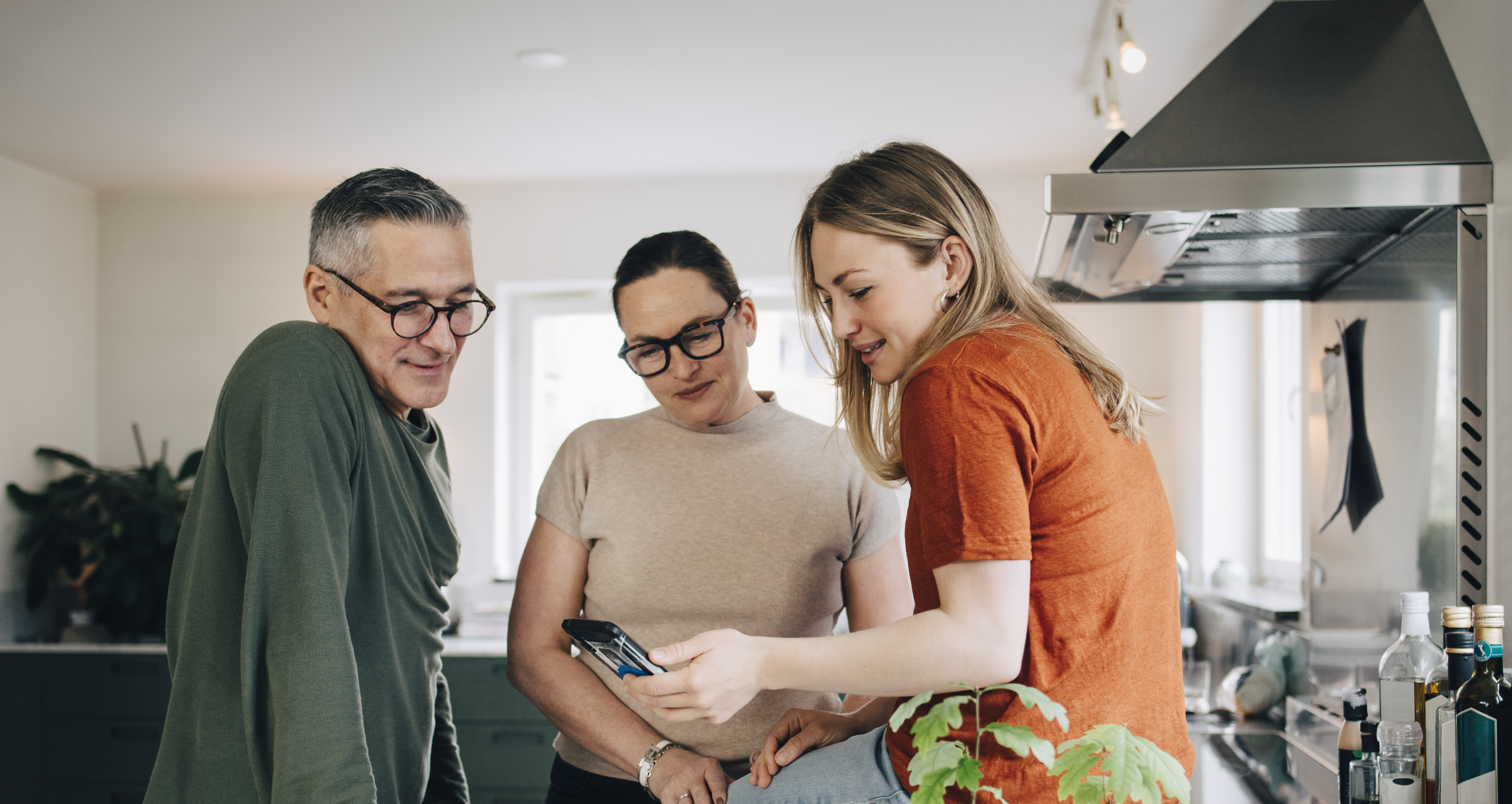 Family sitting on kitchen counter.