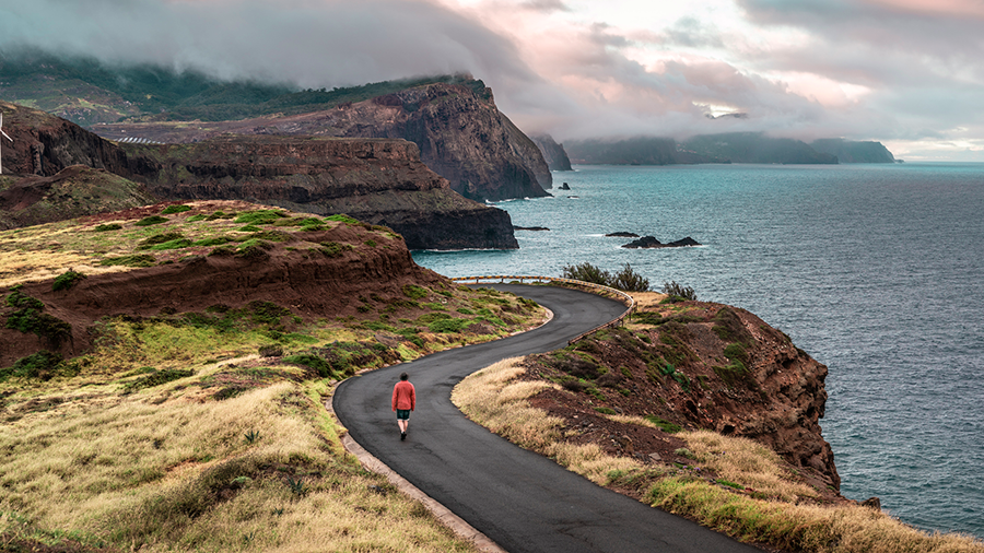 A person walks a winding road