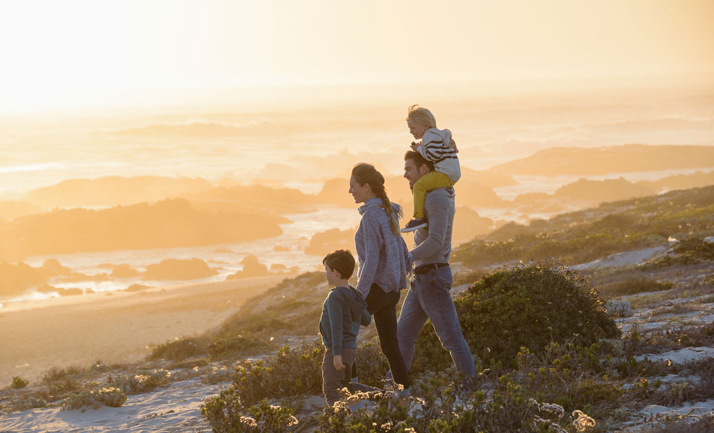 Family of four in the mountains looking at the scenery