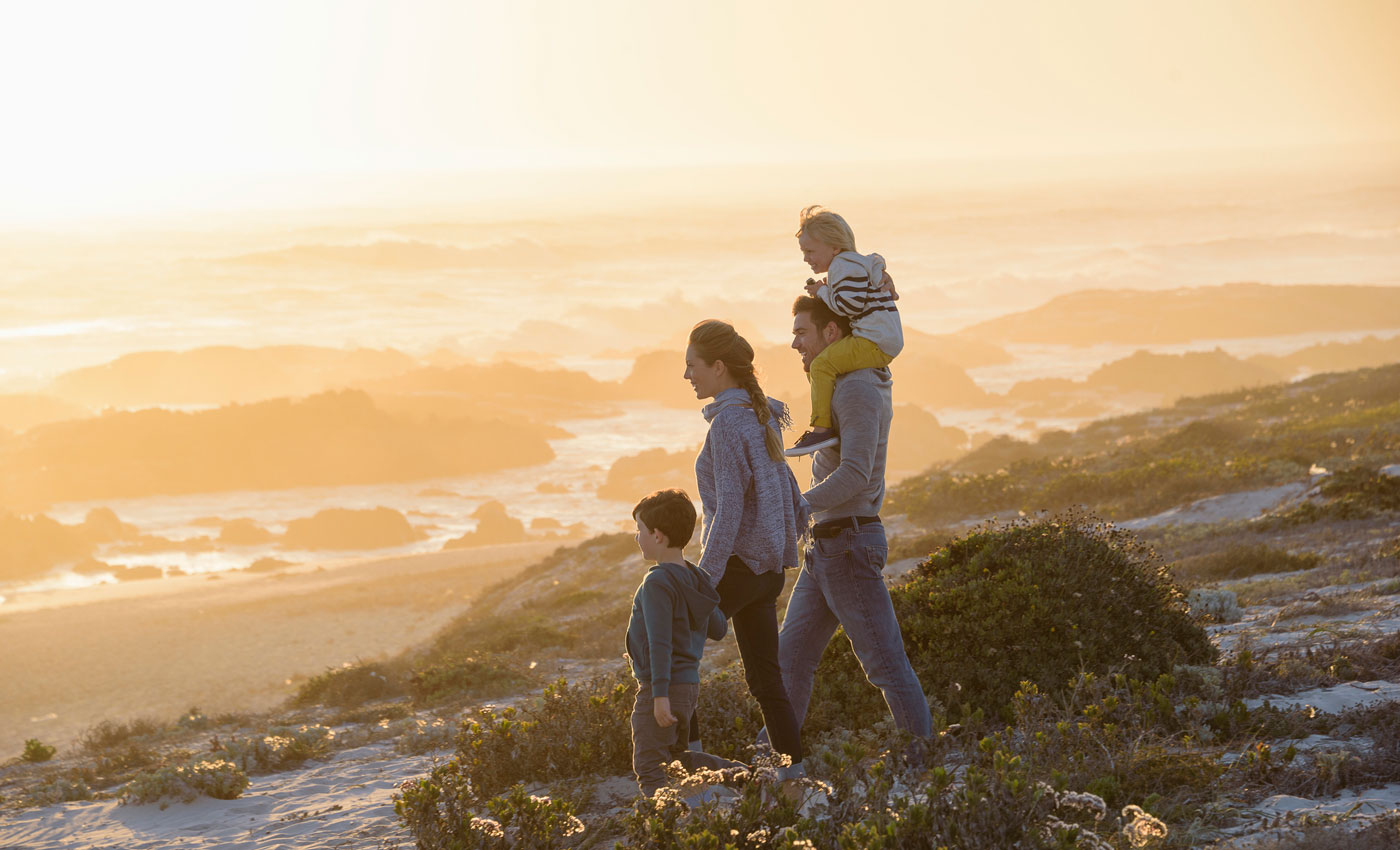 Family of four in the mountains looking at the scenery