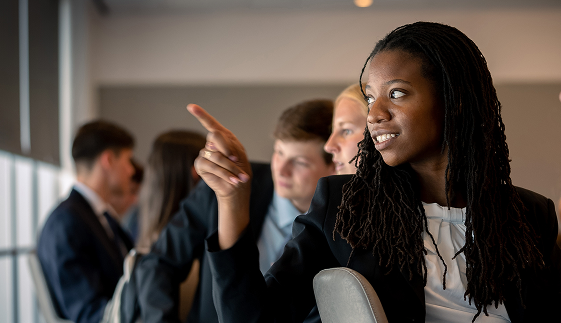 Interns looking curiously pointing toward the presentation